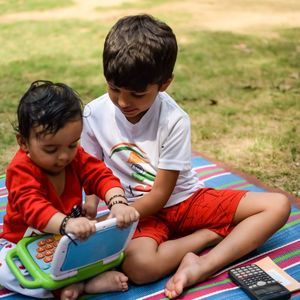 Two happy boys in society park, happy asian brothers who are smiling happily together. brothers play