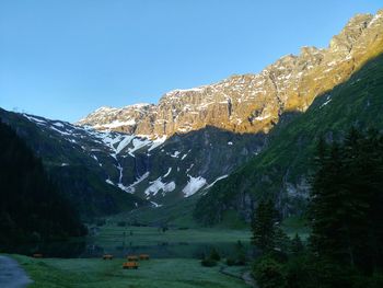 Scenic view of mountains against clear blue sky