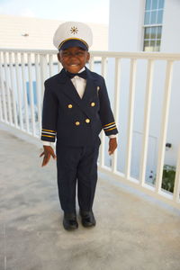 Happy little boy in dress up captain uniform