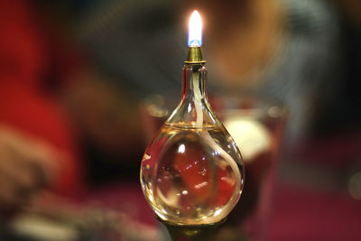 Close-up of lit oil lamp