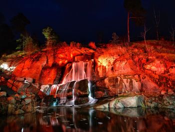 Water flowing through rocks at night