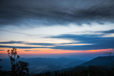 Scenic view of mountains against sky at sunset