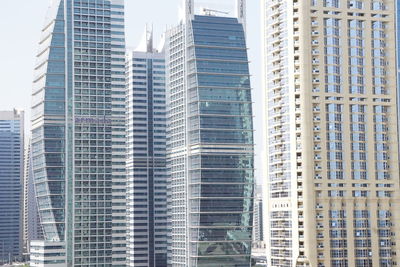 Low angle view of modern buildings in city against sky