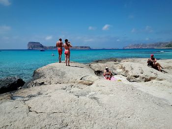 People on beach against sky