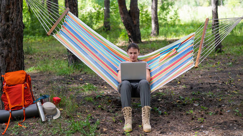 Man sitting on chair in park