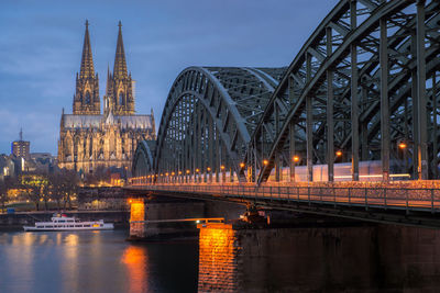 Bridge over river amidst buildings in city