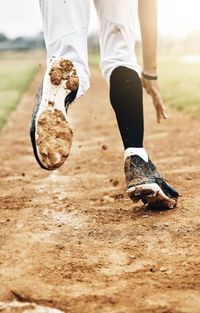 Low section of man running on beach