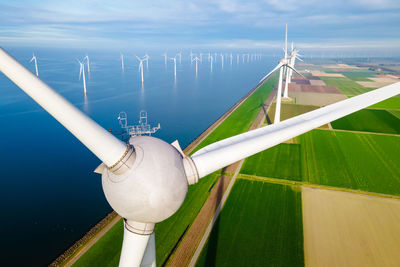 Low angle view of windmill against sky