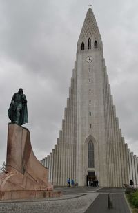 Low angle view of hallgrimskirkja against cloudy sky at dusk