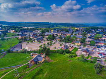 High angle view of houses on field against sky