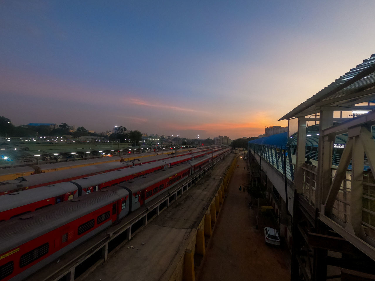 PANORAMIC VIEW OF ILLUMINATED CITY AT SUNSET