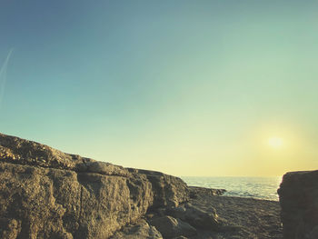 Scenic view of sea against clear sky during sunset