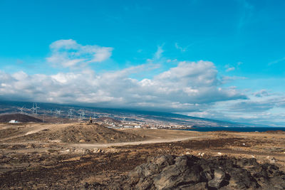 Scenic view of beach against blue sky