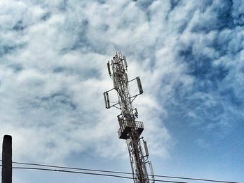 Low angle view of tower against cloudy sky