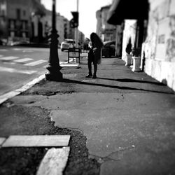 Man walking on road in city