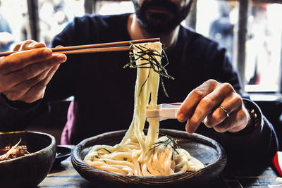 Man eating udon noodles