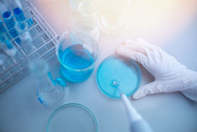 Cropped hand of scientist examining chemical in laboratory