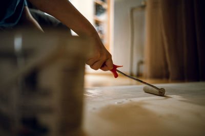 Midsection of woman painting on table