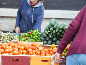 Cropped image of vendor selling vegetables at market