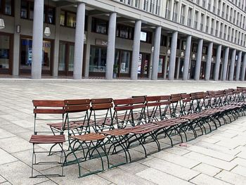 Empty chairs against building