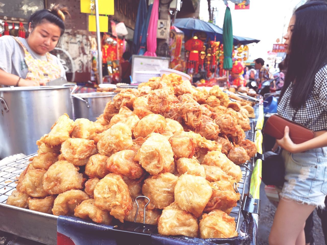 food and drink, food, incidental people, real people, retail, women, freshness, adult, market, market stall, lifestyles, business, choice, people, group of people, variation, for sale, abundance, focus on foreground, buying