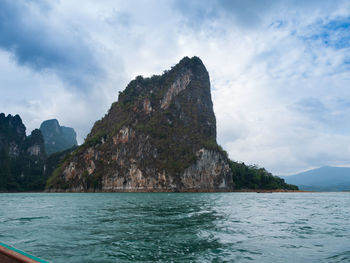 Scenic view of sea and mountains against sky