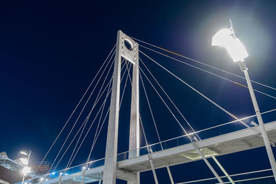 Low angle view of illuminated bridge against sky at night