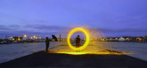 Man spinning wire wool at dusk