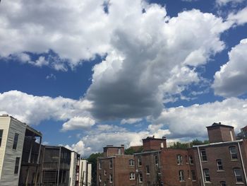 View of cityscape against cloudy sky