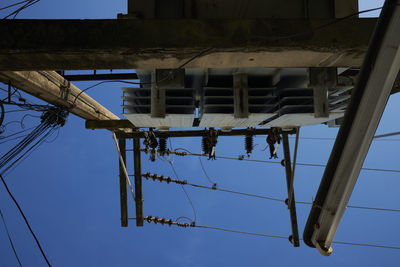 Low angle view of electricity pylon against clear sky