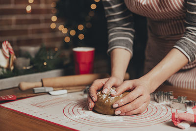 Christmas gingerbread cooking, cake, biscuit, strudel baking. woman in apron is kneading dough