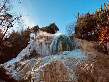 Panoramic view of rocks in forest against sky