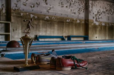 Trophy by shoes on table