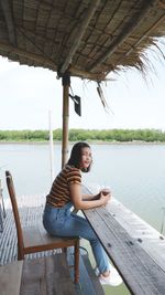 Portrait of women sitting by lake