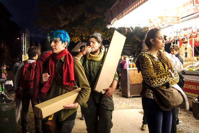 Woman standing against people