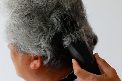 Close-up portrait of man using mobile phone