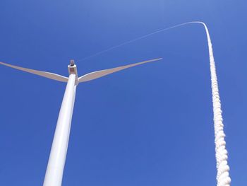 Low angle view of rope and windmill against clear blue sky