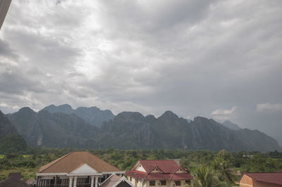 Houses on mountain against sky