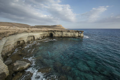 Scenic view of sea against cloudy sky