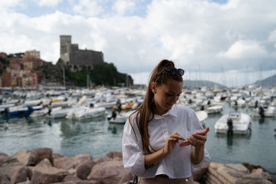 Woman standing in city against sky