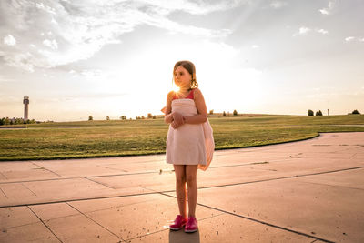 Portrait of woman standing on land against sky