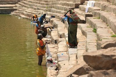 High angle view of people walking on river