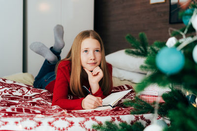 Portrait of teenage girl sitting at home