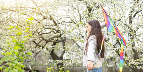 Little cute girl flying a kite