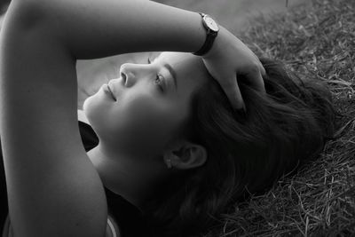 Close-up of woman lying down on field