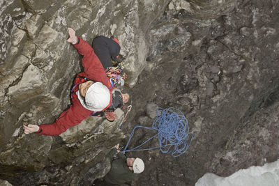 Female climber climbing sea cliff in swanage / england