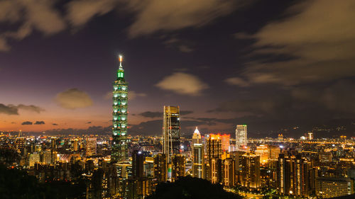 Panoramic view of illuminated buildings against sky at night