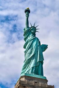 Statue of liberty against cloudy sky