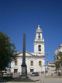 Low angle view of building against clear blue sky