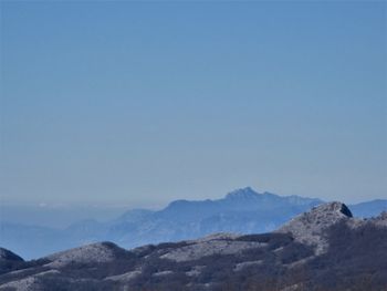 Scenic view of mountains against clear blue sky